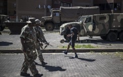  soldiers patrol a residential complex in Westbury, Johannesburg. AFP/Marco Longari