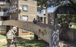 Police officers and soldiers search a building during a patrol operation in Westbury. AFP/Ilaria Finizio