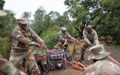 Soldiers recover generators left behind by artisanal miners. AFP/Emmanuel Croset