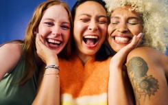 Three women laughing together. GettyImages/pixdeluxe