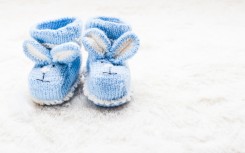 Blue baby booties. GettyImages/oksix