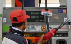 A man refuels the tank of a motorcycle at a petrol station in Manila. AFP/Jam Sta Rosa