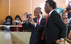 Economic Freedom Fighters (EFF) leader Julius Malema (CL) and a member of his legal team Tembeka Ngcukaitobi (CR) stand in the dock at the KuGompo City Regional court in East London on April 15, 2026 for his sentencing for firing an assault rifle at a rally eight years ago.