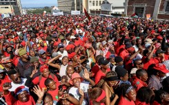 Supporters of Economic Freedom Fighters (EFF) leader Julius Malema listen to his speech outside the KuGompo City Regional court in East London on April 15, 2026 following his sentencing for firing an assault rifle at a rally eight years ago.