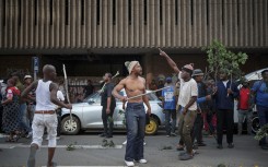 Protestors gesture in the street during a protest march against undocumented migrants organised by “March and March” in Johannesburg on April 29, 2026.