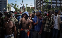 Protestors hold branches and sticks during a protest march against undocumented migrants organised by “March and March” in Johannesburg on April 29, 2026.