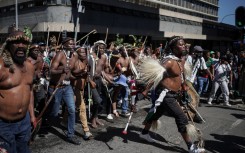 Protestors walk on a street during a protest march against undocumented migrants organised by “March and March” in Johannesburg on April 29, 2026.
