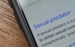 The words 'sexual predator' seen on a phone. GettyImages/Abu Hanifah