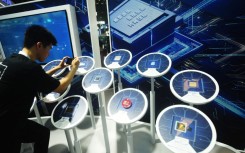 File: A visitor looking at domestic and foreign artificial intelligence chips. CFOTO/NurPhoto via AFP