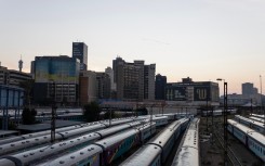 A general view of Shosholoza Meyl train carriages with the skyline of Braamfontein, Johannesburg, in the background on March 28, 2026. (Photo by Wikus de Wet / AFP)
