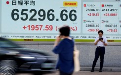 An electronic quotation board (L) displays the Nikkei Stock Average on the Tokyo Stock Exchange. AFP/Kazuhiro Nogi