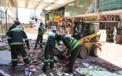 City Of Johannesburg officials work during a by-law enforcement operation to reclaim public spaces, restore law and order and remove illegal structures in the inner city. Gallo Images/Luba Lesolle