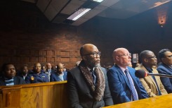 Vusimuzi 'Cat' Matlala in court, behind him is suspended SAPS National Commissioner General Fannie Masemola.