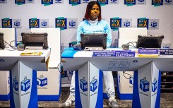 An official sits at a voter registration table at the launch event for the 2026 Municipal elections. Per-Anders Pettersson/Getty Images