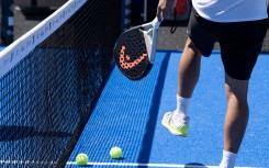 A ball and racket used to play padel tennis. AFP/Alain Jocard
