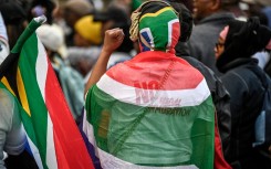Protesters chant slogans as they march during a demonstration by the "March and March" and Operation Dudula movements. AFP/Rodger Bosch