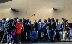 Zimbabwean nationals line up as they wait to be registered at a Department of Home Affairs Refugee Reception Centre. AFP/Rodger Bosch