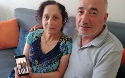 Kerban Kalin and Ali Kalin show a photograph of their son Cadet Officer Alper Kalin who has been serving a life sentence following the last coup in Turkey.