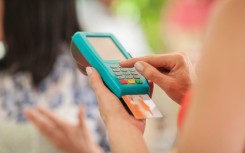 File: A person paying a trader with a credit card. Zero Creatives/Connect Images via AFP