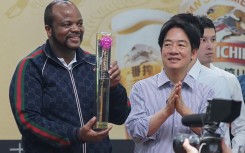 King Mswati III of Eswatini (L) holds his prize next to Taiwan's President-elect Lai Ching-te (R)