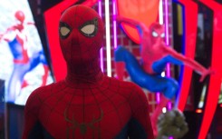A man dressed as Spider-Man poses in front of a Marvel Studios Spider-Man booth. Ying Tang/NurPhoto via AFP