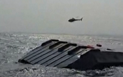 A helicopter circling the capsized ferry. AFP/UCG