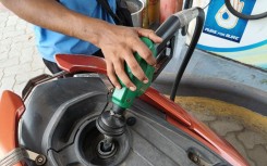 A petrol pump attendant fills fuel in a vehicle at a petrol station. Debajyoti Chakraborty/NurPhoto via AFP