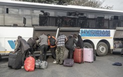 Documented foreign nationals pack their belonging in a bus in Durban for relocation to the Lindela Repatriation Centre in Gauteng. AFP/Rajesh Jantilal