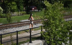 A woman jogs along a canal in Montreal, Quebec, Canada, on August 21, 2026. (Photo by Graham Hughes/NurPhoto via Getty Images)