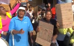 The Kempton Park community and local runners are gathered outside the Kempton Park Police Station.