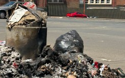 Rubbish piling up next to a bin. eNCA/Aviwe Mtila