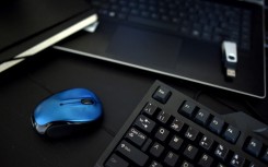 File: A desk with a keyboard, a mouse and a laptop. AFP
