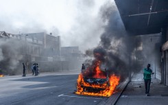 South African Police Service (SAPS) officers intervene as clashes erupt between protesters and foreign nationals in Durban on October 8, 2026.