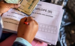 File: An IEC official assisting an elderly voter with a special vote. Gallo Images/Sharon Seretlo