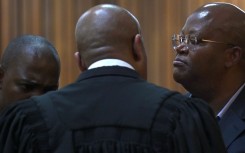 Shaun Abrahams speaks with his two clients Kabelo John Matsepe and Mamone Daniel Msiza at the Pretoria High Court. Gallo Images/Beeld/Deaan Vivier