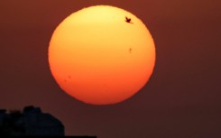 The sun rises over Kuwait City on July 14, 2023 