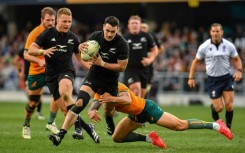 New Zealand's Will Jordan (C) is tackled by Australia's Quade Cooper (R) during the Rugby Championship & Bledisloe Cup Test match between Australia and New Zealand 