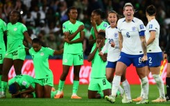 England's players celebrate with Nigeria's crest-fallen after the penalty shootout in Brisbane