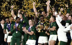 Captain Siya Kolisi (C) holds the Webb Ellis Cup after South Africa beat England in the 2019 Rugby World Cup final in Japan