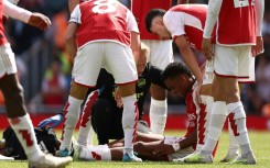 Arsenal's Jurrien Timber (centre) suffered an injury on his Premier League debut