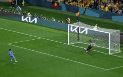 Mackenzie Arnold saves a penalty from France's Kenza Dali during the shootout