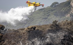 A Royal Moroccan Air Force firefighting plane douses a wildfire in Tangier