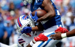 Deon Jackson of Indianapolis, right, is tackled by Buffalo's Damar Hamlin in his return to the NFL in a pre-season game, his first action for the Bills since suffering cardiac arrest in a game last January