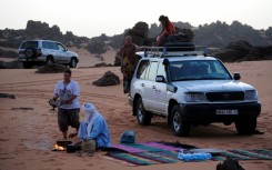Local tour guides set up camp in the desert near the oasis town of Djanet in southeastern Algeria