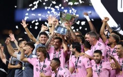 Lionel Messi of Inter Miami hoists the trophy with his teammates after defeating Nashville SC to win the Leagues Cup 