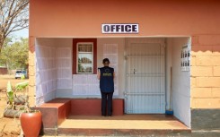 A monitor from the EU Election Observation Mission looks at a voters' list at a polling station during Zimbabwe's elections in Kwekwe