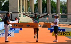 Ethiopia's Amane Beriso Shankule celebrates as she crosses the finish line to win the women's marathon