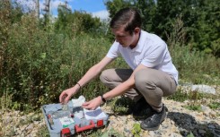 Alexei Zetkin testing water released by a paper factory on the bank of the Sura river in Penza