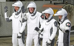 (From L) Konstantin Borisov, Andreas Mogensen, Jasmin Moghbeli and Satoshi Furukawa,  wearing SpaceX spacesuits, wave before they depart for the ISS