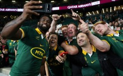 South Africa captain Siya Kolisi celebrates with fans after the Springboks' record 35-7 win over New Zealand at Twickenham